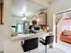 A modern kitchen with breakfast bar and stylish black backsplash, complemented by wood cabinets at 690 W Pearl St, Bartow, FL 33830