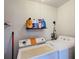 Functional laundry room with washer, dryer, and storage shelf for laundry supplies at 690 W Pearl St, Bartow, FL 33830