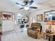 Open floor plan living room showcasing tile floors, a ceiling fan, and a breakfast bar at 690 W Pearl St, Bartow, FL 33830