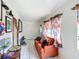 Bright living room featuring tile floors, an orange sofa, and ample natural light at 690 W Pearl St, Bartow, FL 33830