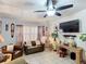 Comfortable living room showcasing tile floors, a ceiling fan, and stylish decor at 690 W Pearl St, Bartow, FL 33830