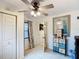 A well-lit room with tile flooring, decorative dresser, and a ceiling fan with light fixture at 690 W Pearl St, Bartow, FL 33830