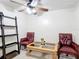 A well-lit room with tile flooring, two chairs, a table, and a ceiling fan with light fixture at 690 W Pearl St, Bartow, FL 33830