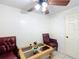 A well-lit room with tile flooring, two chairs, a table, and a ceiling fan with light fixture at 690 W Pearl St, Bartow, FL 33830