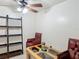 A well-lit room with tile flooring, two chairs, a table, and a ceiling fan with light fixture at 690 W Pearl St, Bartow, FL 33830