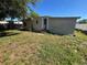 Exterior shot of the back of the house, showing the small yard area and the fence in the background at 6937 Gibraltar Rd, Orlando, FL 32822