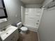 Clean bathroom with a tiled floor, shower-tub combo, and neutral wall color at 6937 Gibraltar Rd, Orlando, FL 32822