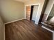 Clean bedroom with a decorative sliding closet door and laminate floors at 6937 Gibraltar Rd, Orlando, FL 32822