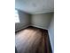 Small bedroom featuring hardwood floors, natural light, and fresh neutral paint at 6937 Gibraltar Rd, Orlando, FL 32822