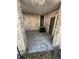 Covered carport entry featuring a stone exterior and convenient access to the front door at 6937 Gibraltar Rd, Orlando, FL 32822