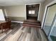 Bright dining room that leads into a room with laminate floors and a ceiling fan at 6937 Gibraltar Rd, Orlando, FL 32822