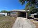 Charming stone-clad home with a covered carport and well-maintained front yard at 6937 Gibraltar Rd, Orlando, FL 32822