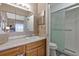 Bathroom featuring a vanity with ample counter space and a shower with a glass enclosure at 7218 Alston Ct, Orlando, FL 32835