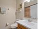 Cozy bathroom featuring a toilet, a sink, and a wall mirror at 7218 Alston Ct, Orlando, FL 32835