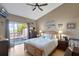 Bedroom boasting a sliding glass door and natural light, featuring a wooden bed frame and neutral decor at 7218 Alston Ct, Orlando, FL 32835