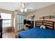 Bedroom featuring a unique husky dog pillow, computer setup, and katana swords above the bed at 7218 Alston Ct, Orlando, FL 32835