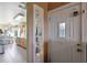 View of the entrance showcasing a tiled floor, white door with glass detail, and a view of the kitchen at 7218 Alston Ct, Orlando, FL 32835