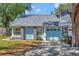 Charming single Gathering home featuring a blue exterior, a garage, and a well-maintained front yard at 7218 Alston Ct, Orlando, FL 32835