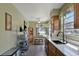 Bright kitchen featuring tile flooring, white countertops, a stainless steel sink and ample cabinet space at 7218 Alston Ct, Orlando, FL 32835