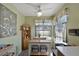 Well-lit eat-in kitchen with ceiling fan, natural light and breakfast nook with seating for a casual dining experience at 7218 Alston Ct, Orlando, FL 32835