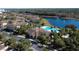 Community aerial view showcasing the pool, lake, and multiple residential buildings, with lush landscaping and ample parking at 7544 Sunville Ave # 7544, Kissimmee, FL 34747
