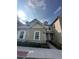 Well-maintained two-story townhome with sidewalks, neutral siding, and a manicured lawn at 7544 Sunville Ave # 7544, Kissimmee, FL 34747