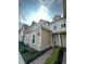 Charming two-story townhome with neutral siding, stone accents, and a brick walkway at 7544 Sunville Ave # 7544, Kissimmee, FL 34747