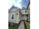 Charming two-story townhome with neutral siding, stone accents, and a brick walkway at 7544 Sunville Ave # 7544, Kissimmee, FL 34747