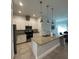 Modern kitchen features stainless steel appliances, a center island, and pendant lighting at 7544 Sunville Ave # 7544, Kissimmee, FL 34747