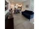 Open-concept living and dining area with tile flooring and modern furnishings at 7544 Sunville Ave # 7544, Kissimmee, FL 34747