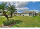 Expansive backyard featuring a lush green lawn and mature palm trees at 801 Ashton Dr, Davenport, FL 33837