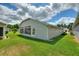 View of house from backyard featuring large green lawn and sunroom at 801 Ashton Dr, Davenport, FL 33837