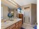 Bathroom features a double sink vanity, large mirror, and a shower with glass doors at 801 Ashton Dr, Davenport, FL 33837