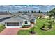 Aerial view of charming home with a brick driveway and well-manicured lawn at 801 Ashton Dr, Davenport, FL 33837