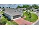 Aerial view of house featuring brick driveway and well-manicured lawn at 801 Ashton Dr, Davenport, FL 33837