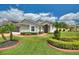 Charming single-story home with lush landscaping, healthy green lawn and inviting entryway and walkway at 801 Ashton Dr, Davenport, FL 33837