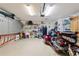 Spacious garage featuring overhead lighting and plenty of storage and motor trike at 801 Ashton Dr, Davenport, FL 33837