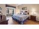 Comfortable main bedroom with hardwood floors, large window view, and stylish decor at 801 Ashton Dr, Davenport, FL 33837