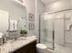 Bathroom vanity with granite counters and a shower with glass doors at 8039 Oak Shadow Ct, Davenport, FL 33837