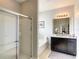 Bathroom with modern walk-in shower, tub, and vanity with granite countertop at 8039 Oak Shadow Ct, Davenport, FL 33837