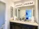 Elegant bathroom showcasing double sinks with granite countertops and decorative details, leading to the bedroom at 8039 Oak Shadow Ct, Davenport, FL 33837