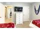 Spacious bedroom featuring a dresser, mounted TV, and two twin beds at 8039 Oak Shadow Ct, Davenport, FL 33837