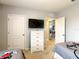 Bright bedroom features twin beds, a dresser, a TV, and access to the living area at 8039 Oak Shadow Ct, Davenport, FL 33837