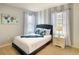 Bedroom with neutral tones and a comfortable queen size bed at 8039 Oak Shadow Ct, Davenport, FL 33837