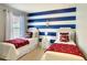 Charming nautical themed bedroom with twin beds and anchor wall decor at 8039 Oak Shadow Ct, Davenport, FL 33837