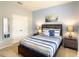 Bedroom with a queen-size bed, side tables, and a double-door closet at 8039 Oak Shadow Ct, Davenport, FL 33837