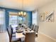 Sophisticated dining room with modern chandelier and access to outdoor lanai with pool view at 8039 Oak Shadow Ct, Davenport, FL 33837