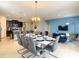 Elegant dining area with seating for ten, connected to the living room and kitchen in an open concept design at 8039 Oak Shadow Ct, Davenport, FL 33837