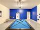 Spacious game room featuring a pool table, seating area, and bright, modern design at 8039 Oak Shadow Ct, Davenport, FL 33837