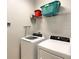 Laundry room with a washer, dryer, and wire shelving at 8039 Oak Shadow Ct, Davenport, FL 33837